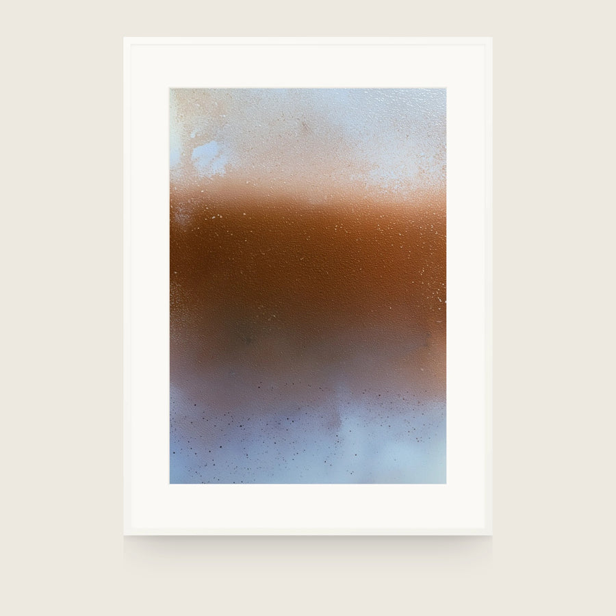 Rust-orange band across the centre of a pale cream and grey-blue field, with fine dark specks scattered in the lower third. Shown framed. Frames and mounts are not included.
