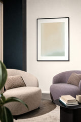 Ceramics XVI — Cream. A near-uniform cream ground with very faint pale speckling and a soft sage form at the lower right. Hung on a wall in a room. Shown framed. Frames and mounts are not included.