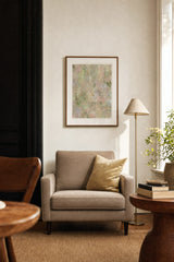 Botanics I — Blossom. Pale abstract in pink and peach with small green marks throughout and a soft swirl at the centre. Hung on a wall in a room. Shown framed. Frames and mounts are not included.