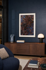 Patina XIII — Cinder. Torn rust-red and black shapes over blue-grey, scattered with gold specks. Hung on a wall in a room. Shown framed. Frames and mounts are not included.