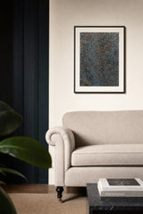 Impressions XI — Gravel. Small blue-grey flakes with orange and rust scattered evenly throughout. Hung on a wall in a room. Shown framed. Frames and mounts are not included.