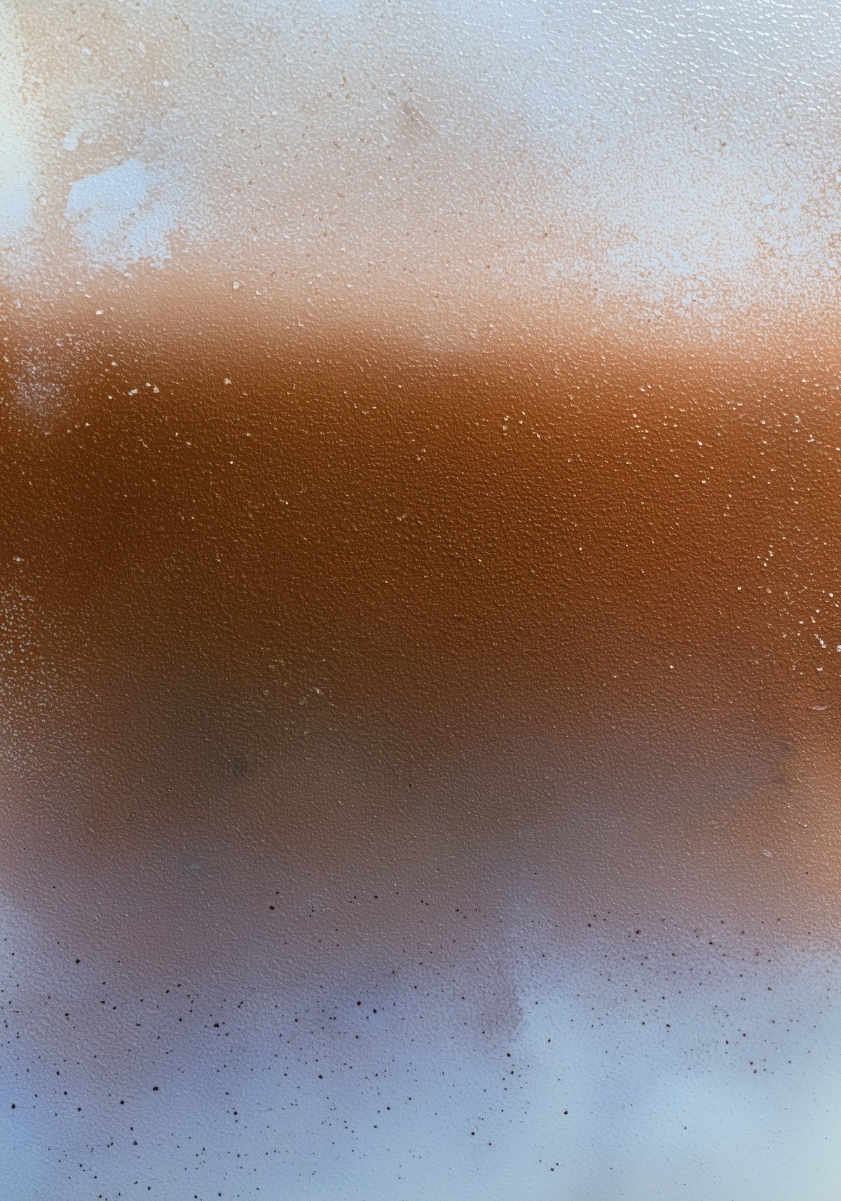 Rust-orange band across the centre of a pale cream and grey-blue field, with fine dark specks scattered in the lower third. Shown framed. Frames and mounts are not included.