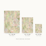 Botanics I — Blossom. Pale abstract in pink and peach with small green marks throughout and a soft swirl at the centre. Three sizes shown side by side to relative scale, unframed.