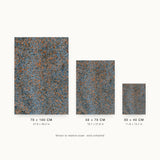 Impressions XI — Gravel. Small blue-grey flakes with orange and rust scattered evenly throughout. Three sizes shown side by side to relative scale, unframed.