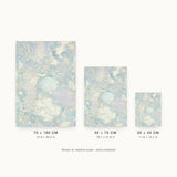 Forestry IX — Mound. Tiny pale blue and lilac fragments, with a large soft rounded form at the centre and cream masses beneath. Three sizes shown side by side to relative scale, unframed.